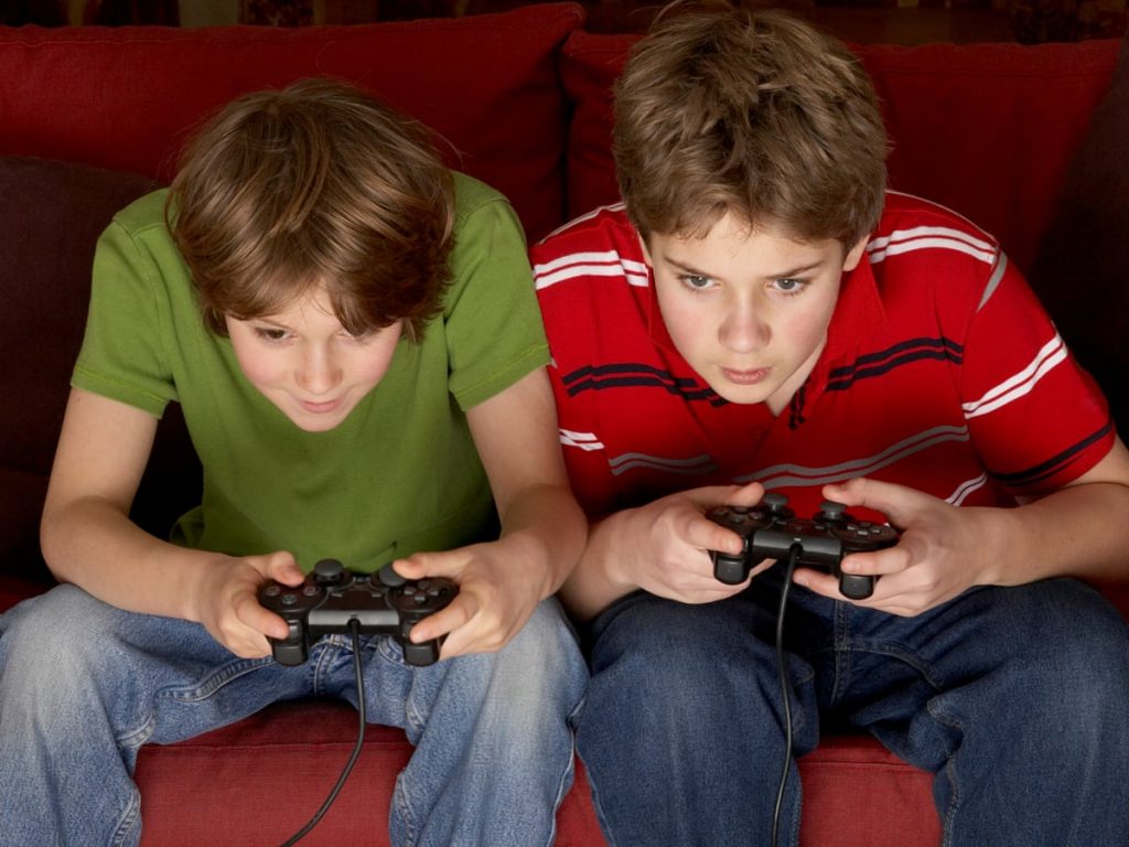 A little boy that is sitting down and looking at the camera